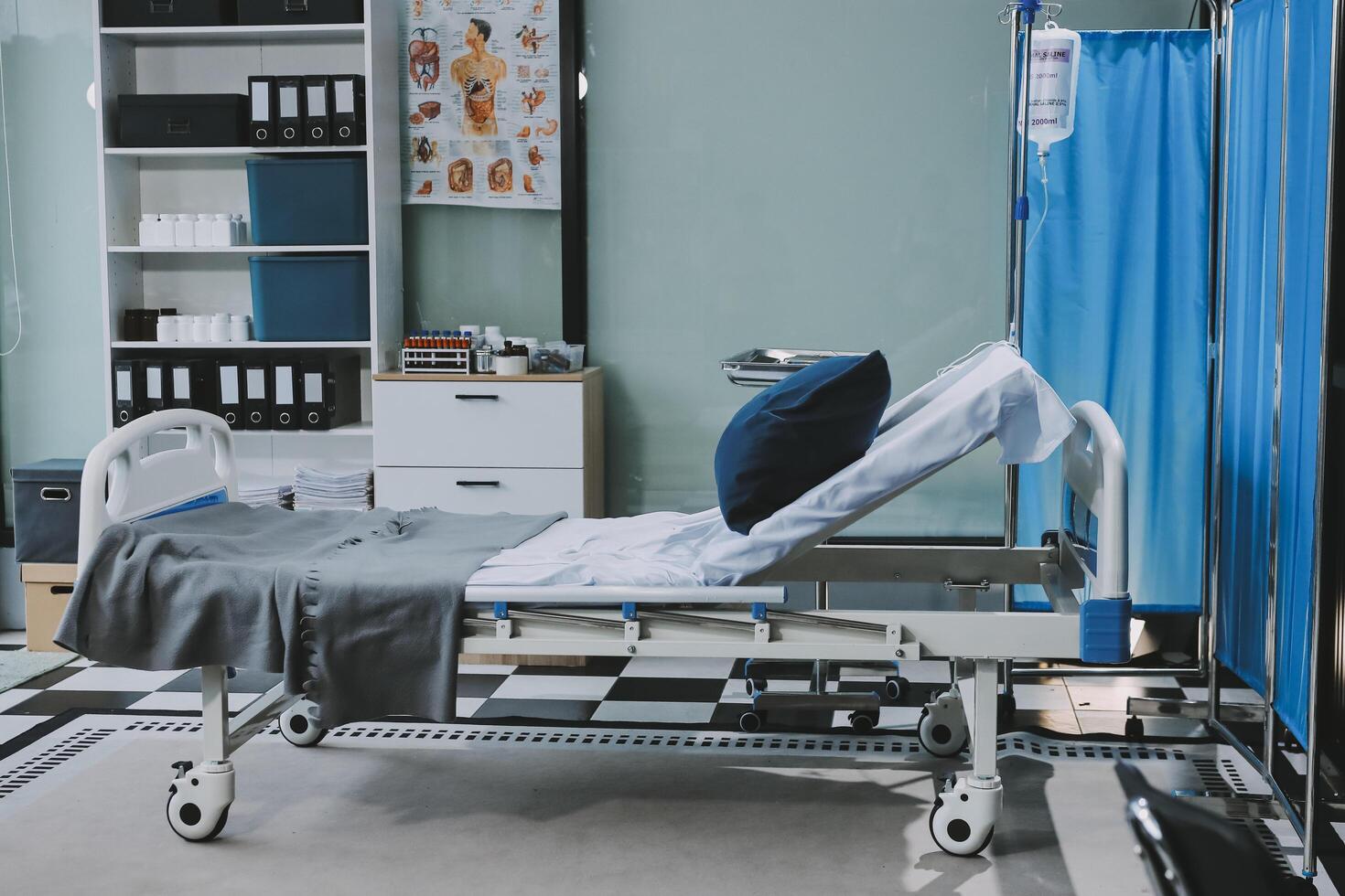 A hospital bed in a room with a blue curtain photo