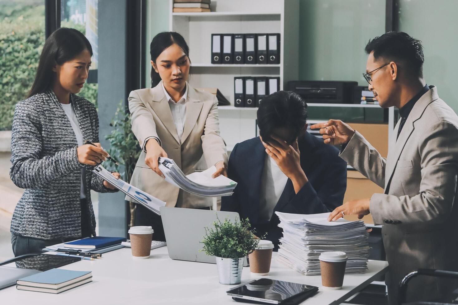 A group of business people working at a desk photo