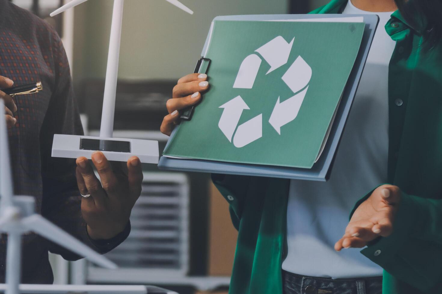 Recycle energy concept - business people holding a folder with a recycling symbol on it photo