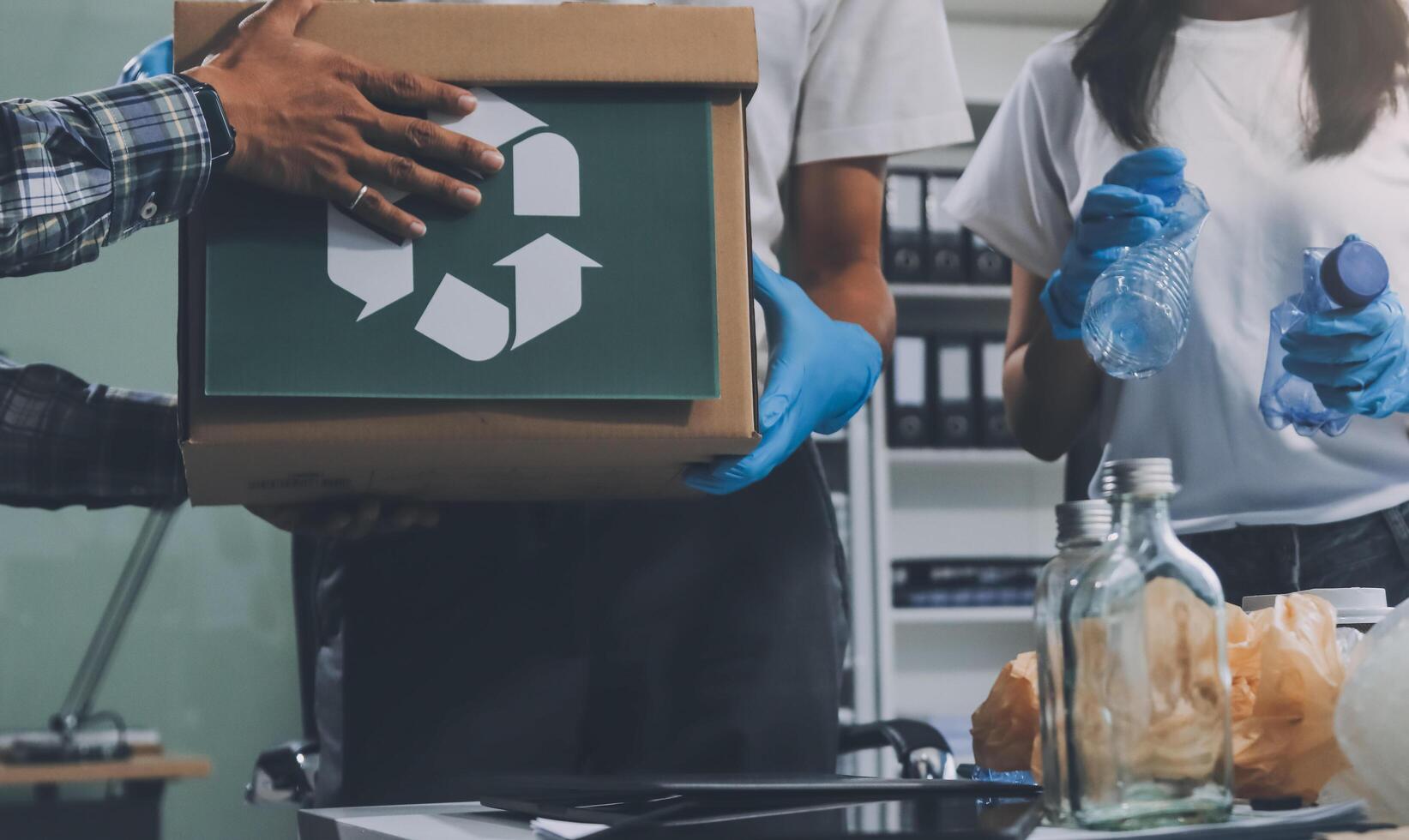 A man and woman are holding a box with recycling symbol photo