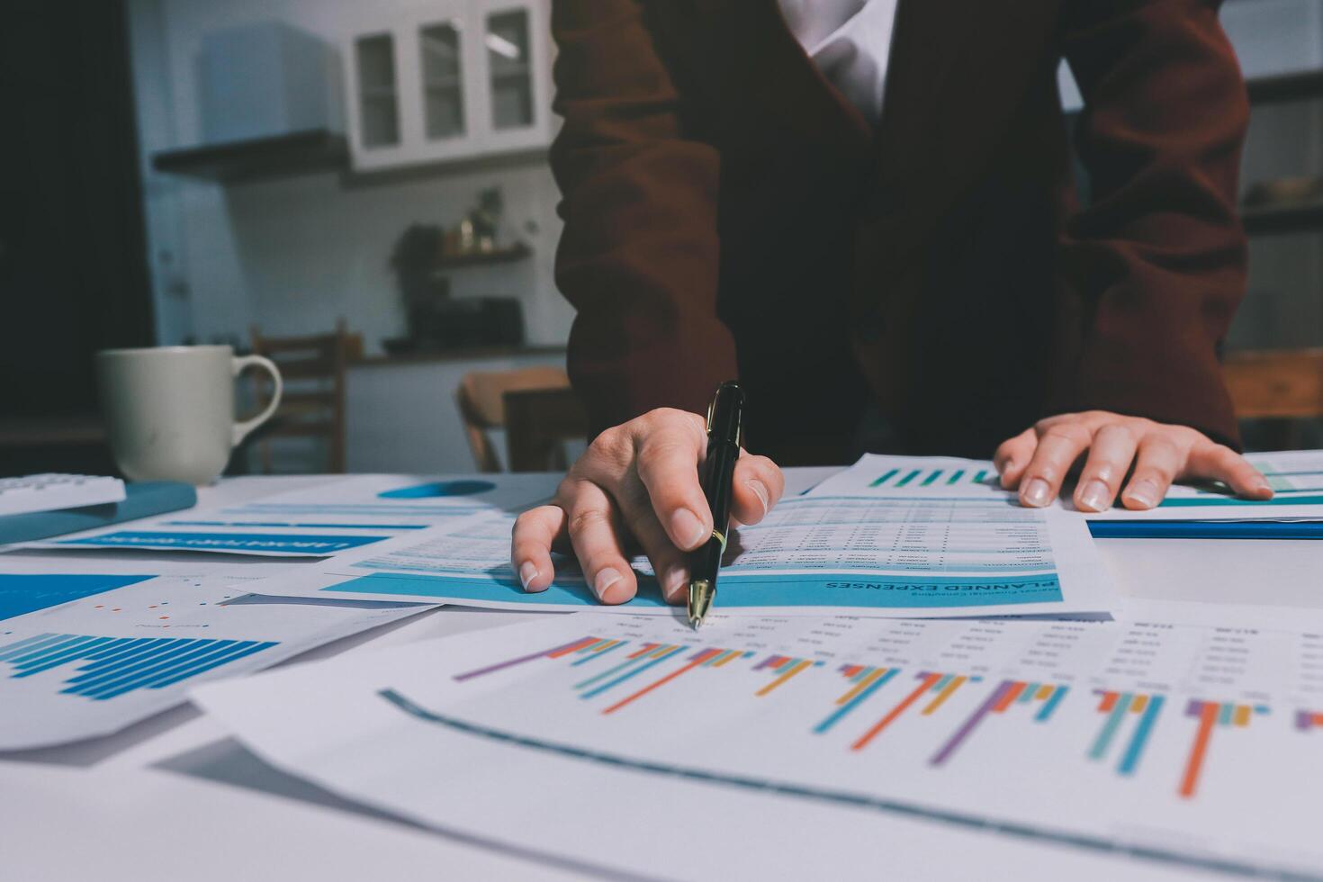 A person in a business suit is looking at graphs on a table photo