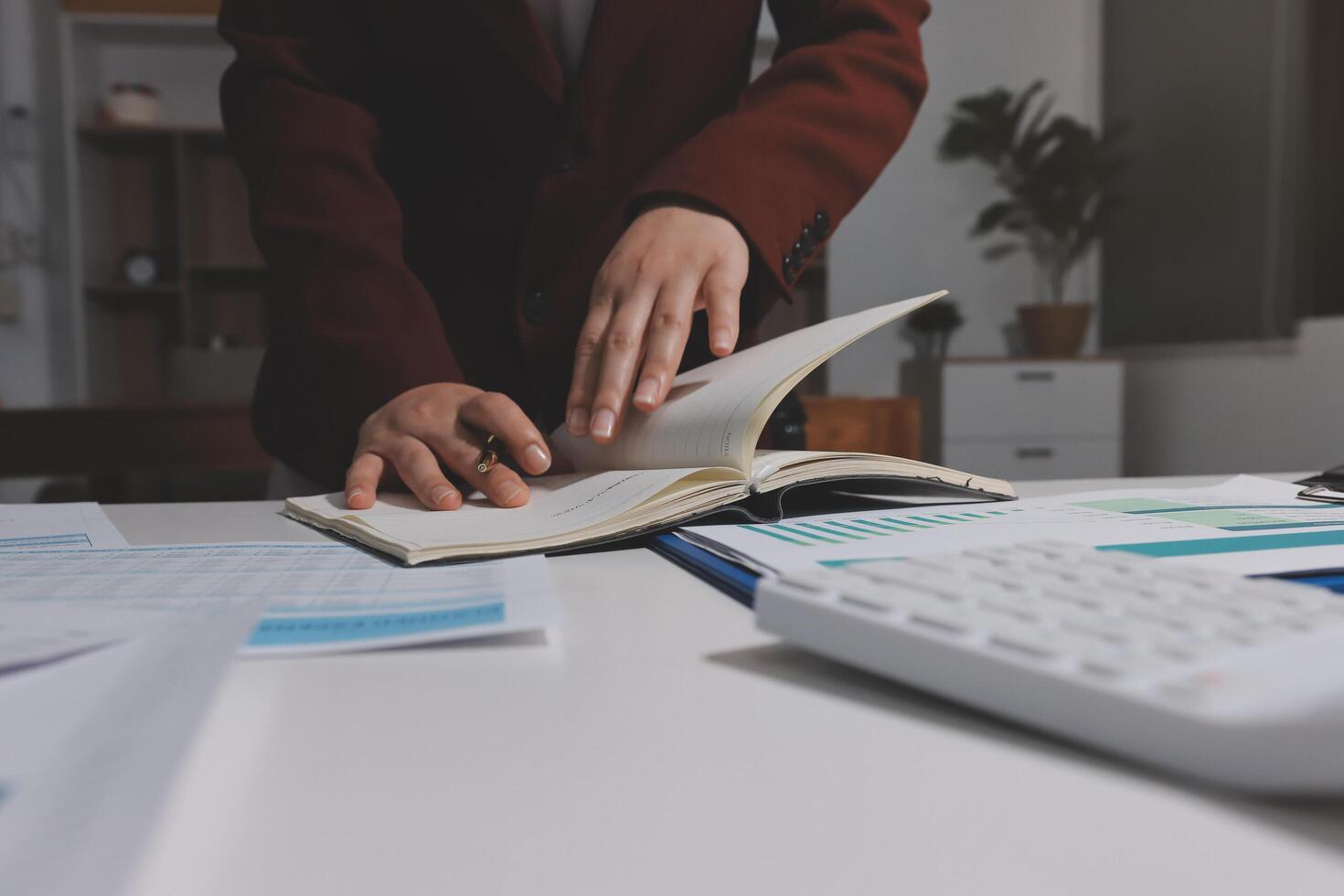 A person is looking at a book on a desk photo