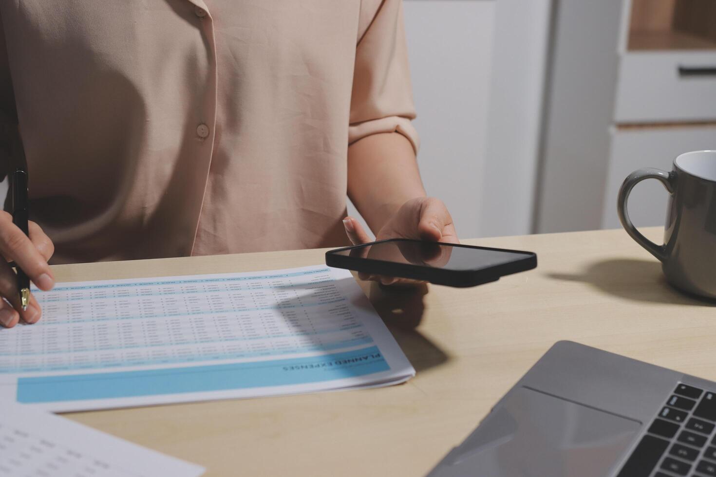 A woman is using her phone to check her tax return photo