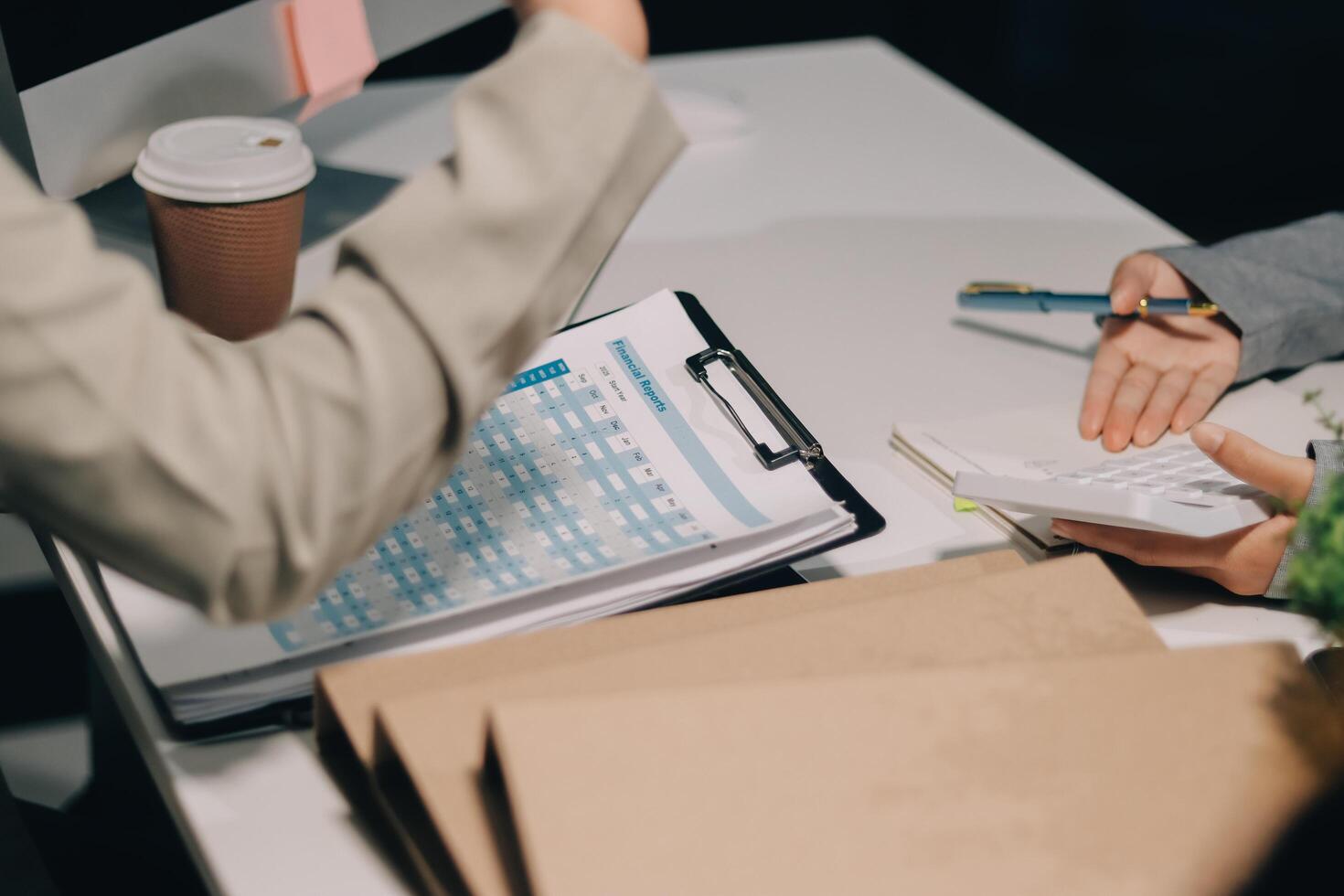 A woman is writing on a clipboard while a man is holding a cup photo