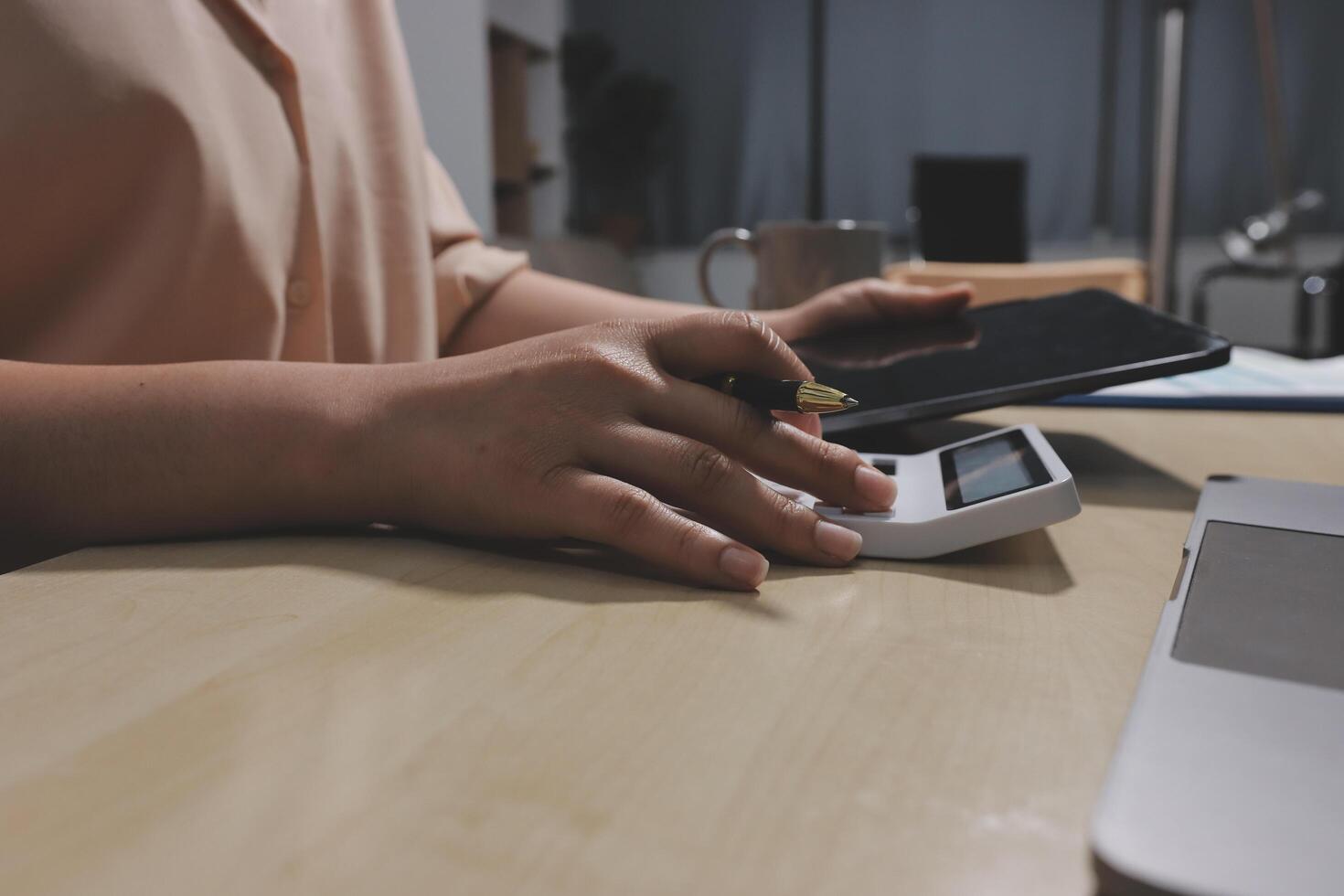 A person using a tablet and a laptop photo