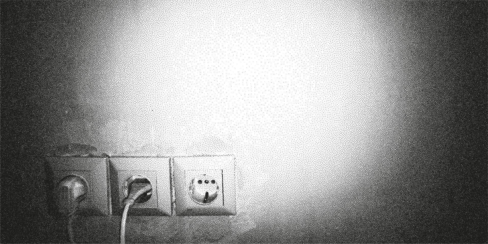 Electrical outlet with cables attached against a textured wall in a well-lit room vector