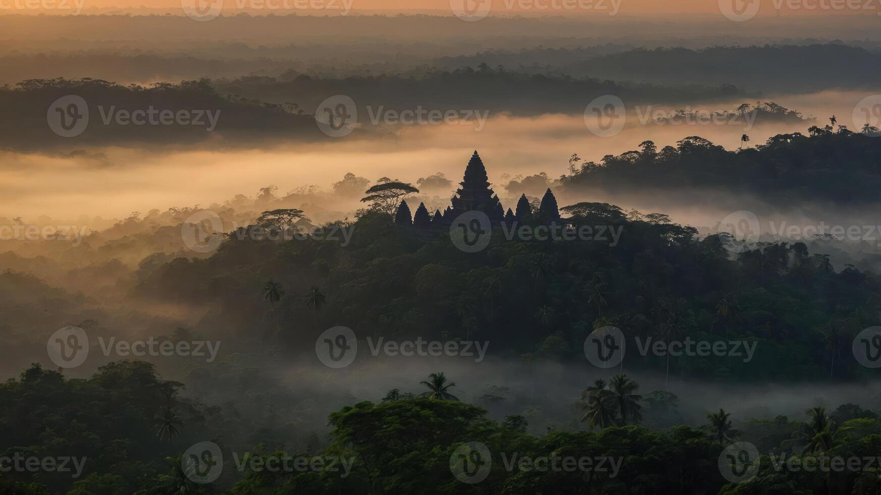 A misty landscape featuring ancient temple ruins surrounded by lush greenery at sunrise. photo