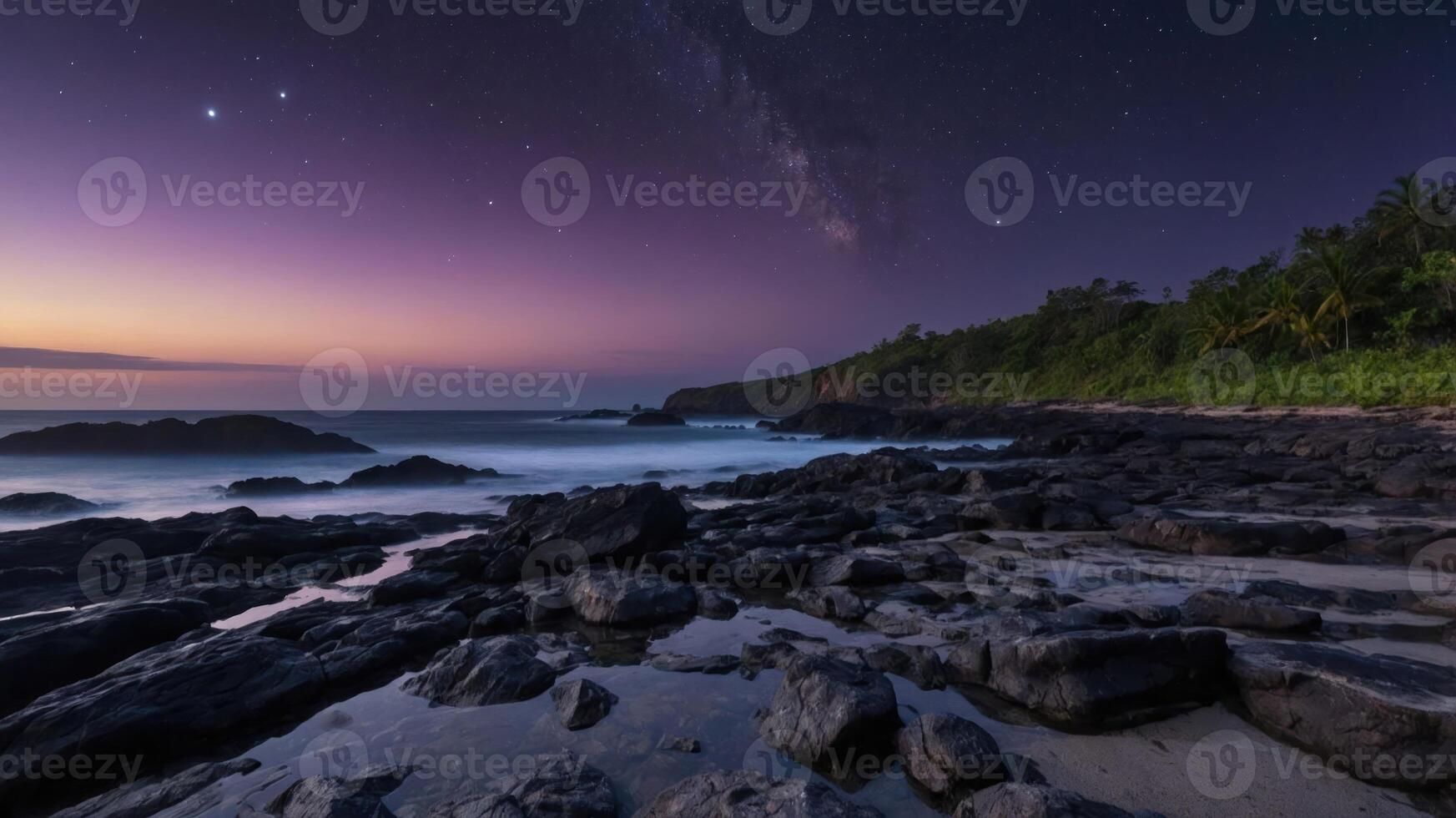 A serene beach scene at twilight, showcasing rocks, gentle waves, and a starry sky with the Milky Way. photo