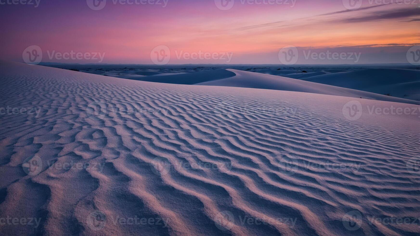 A serene landscape of rolling sand dunes at sunset, showcasing beautiful patterns and colors in the sky. photo