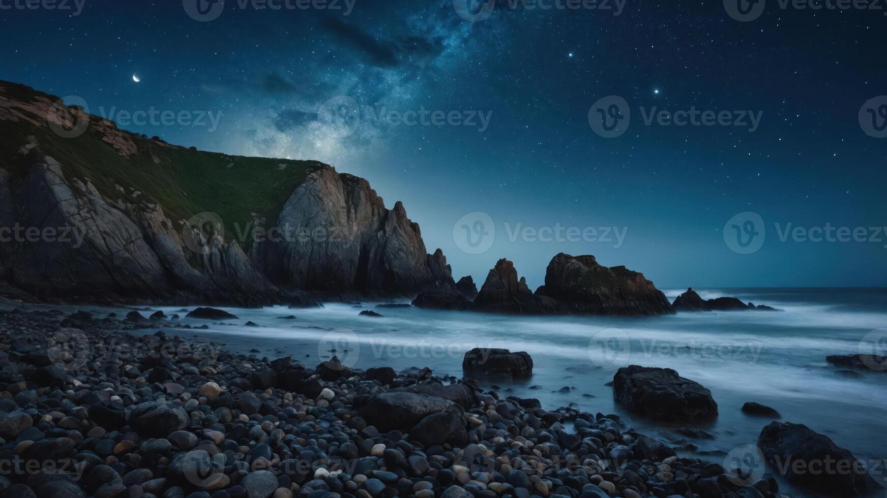 A serene coastal scene under a starry night sky with rocky formations and gentle waves. photo