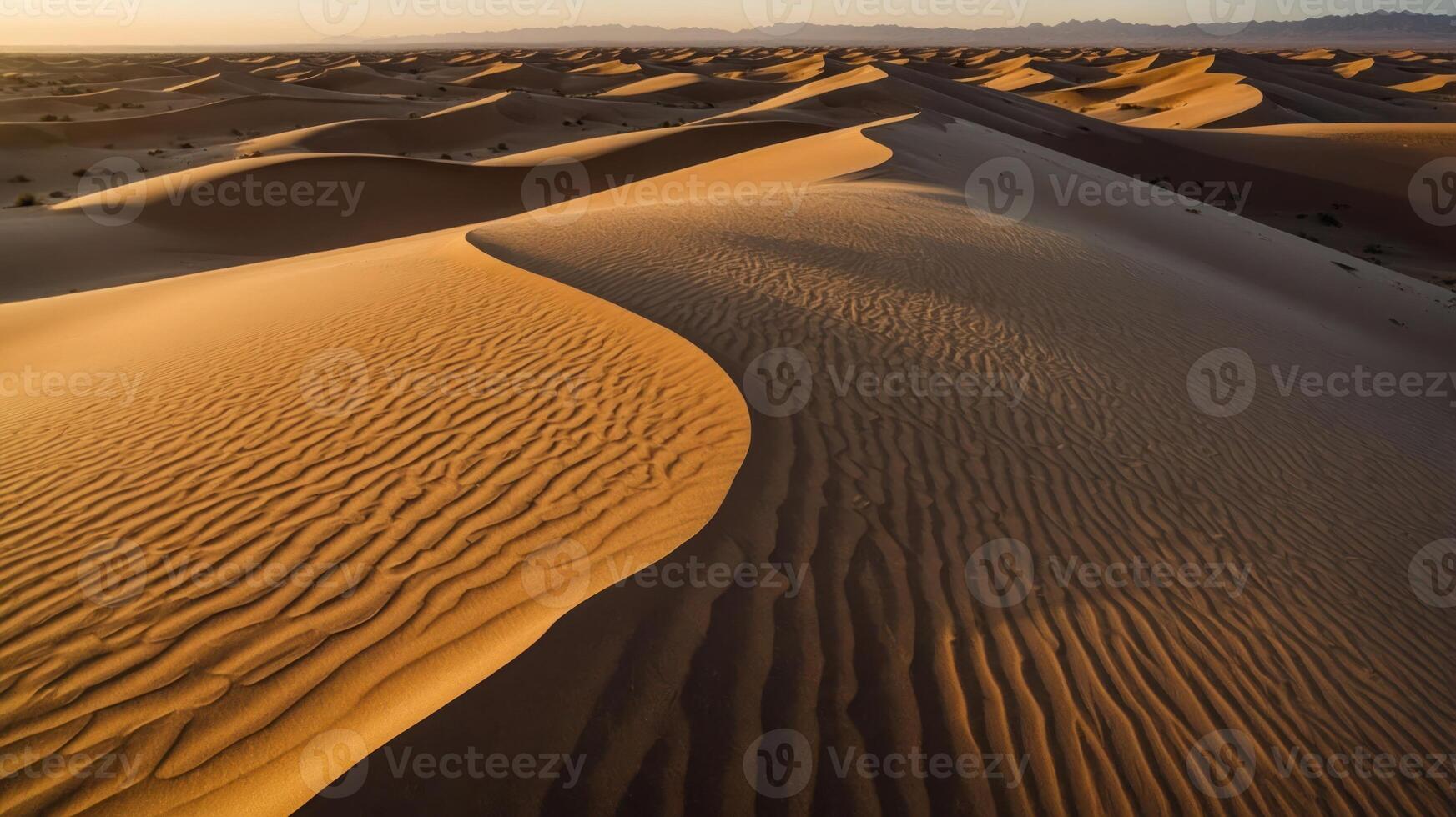 A serene view of sand dunes at sunset, showcasing natural patterns and textures. photo