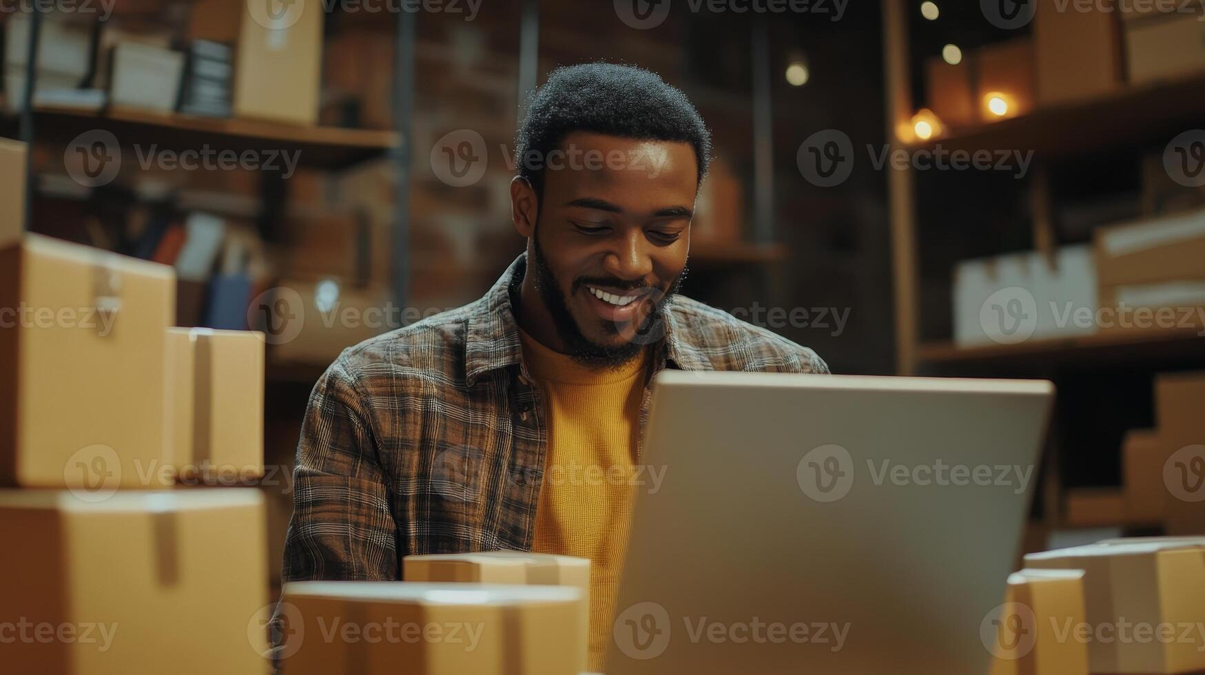 Smiling Business Owner Working on Laptop with Packages photo