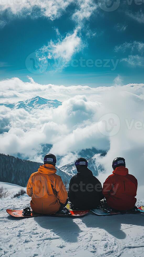 Snowboarders Enjoying the View from a Snowy Mountain Peak photo