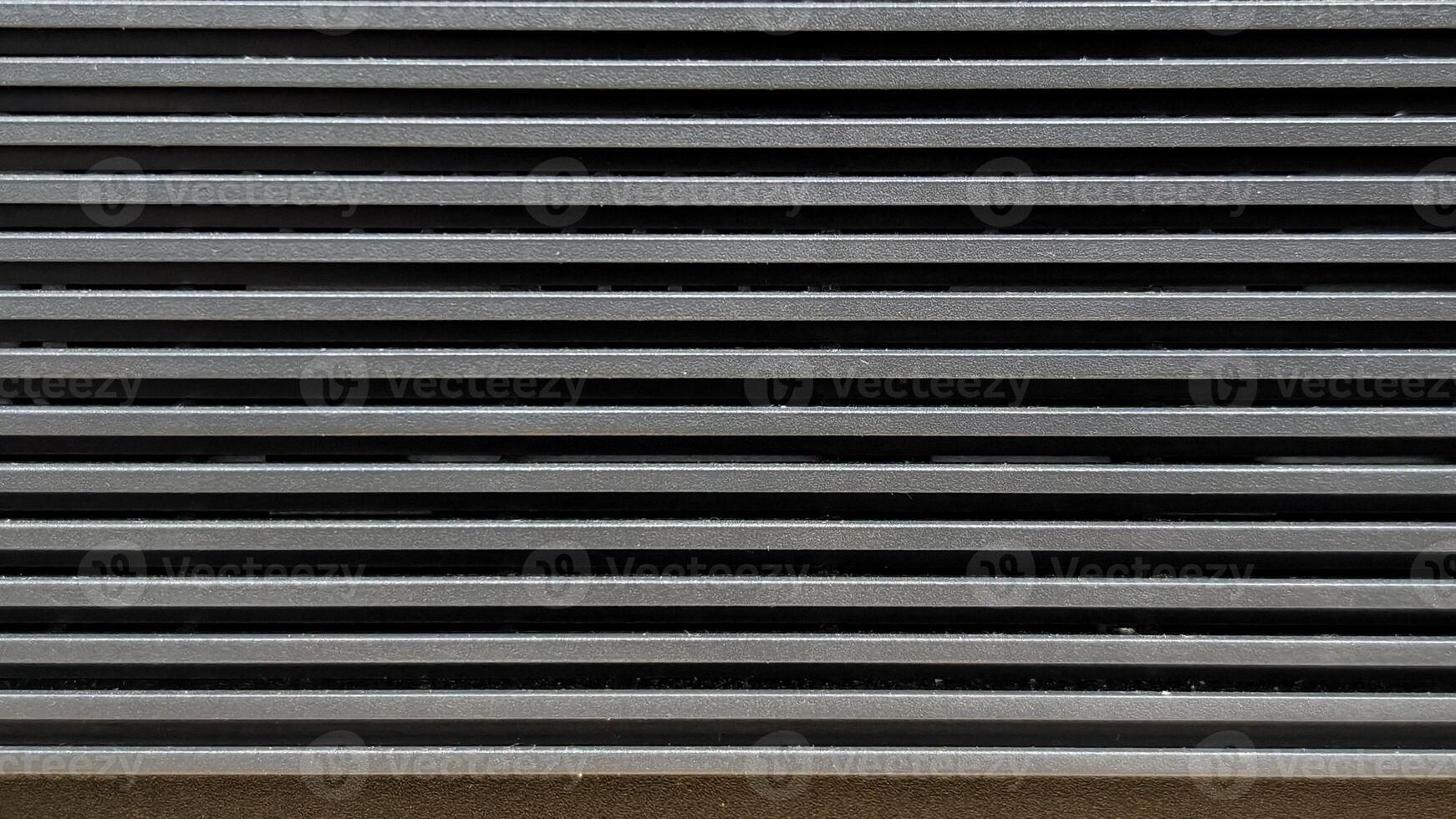 Close up pattern of horizontal metallic ventilation grill slats texture. photo