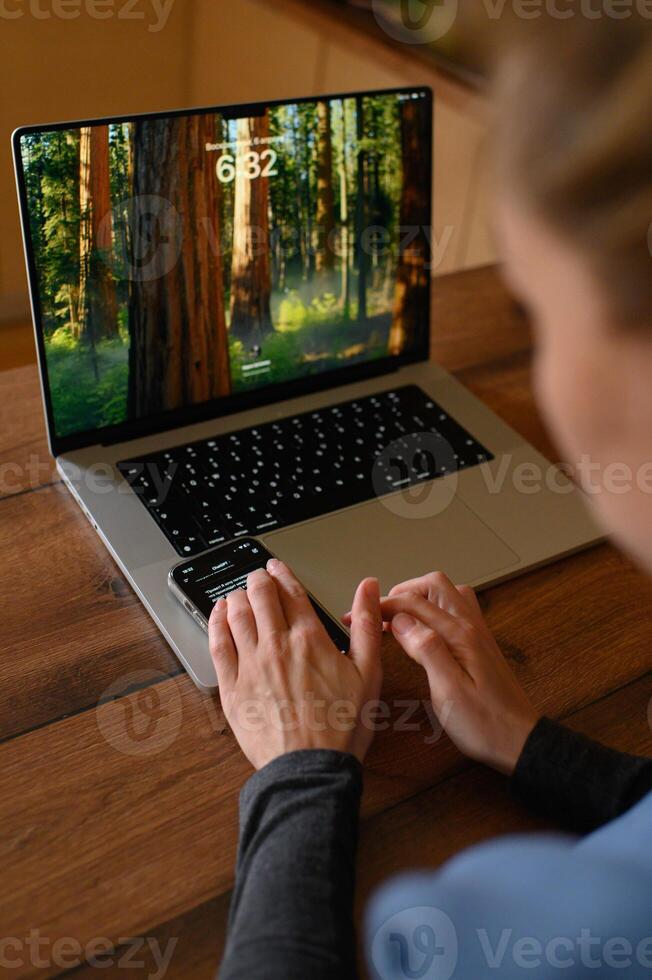 Freelancer uses ChatGPT for assistance while working on her computer. photo