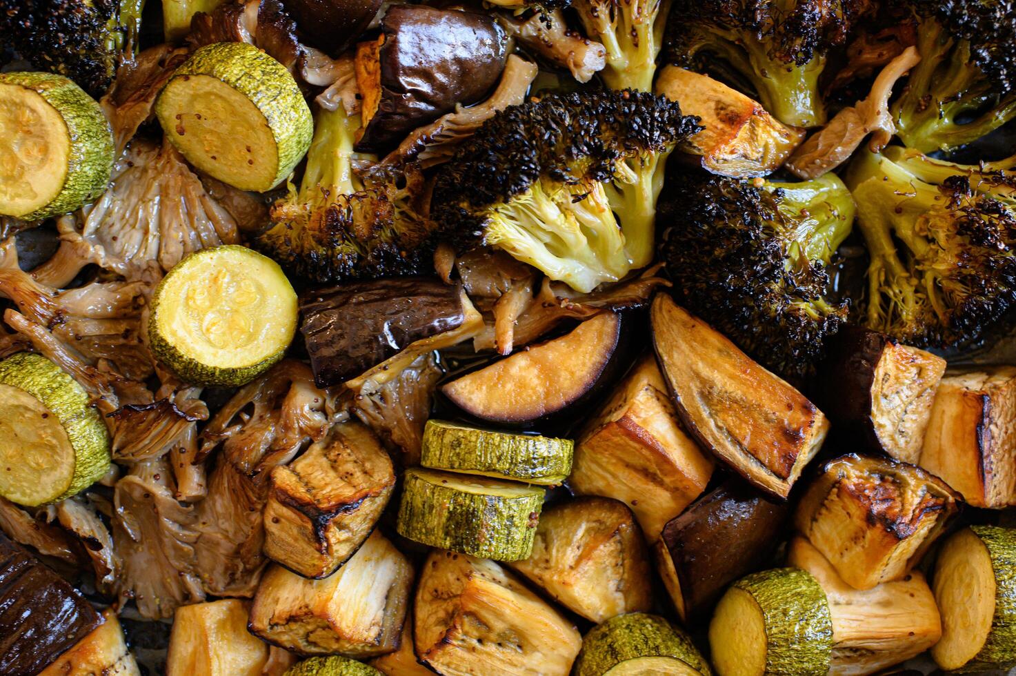 A healthy mix of roasted broccoli, zucchini, mushrooms, and eggplant, with a crispy outer layer and tender inside. photo