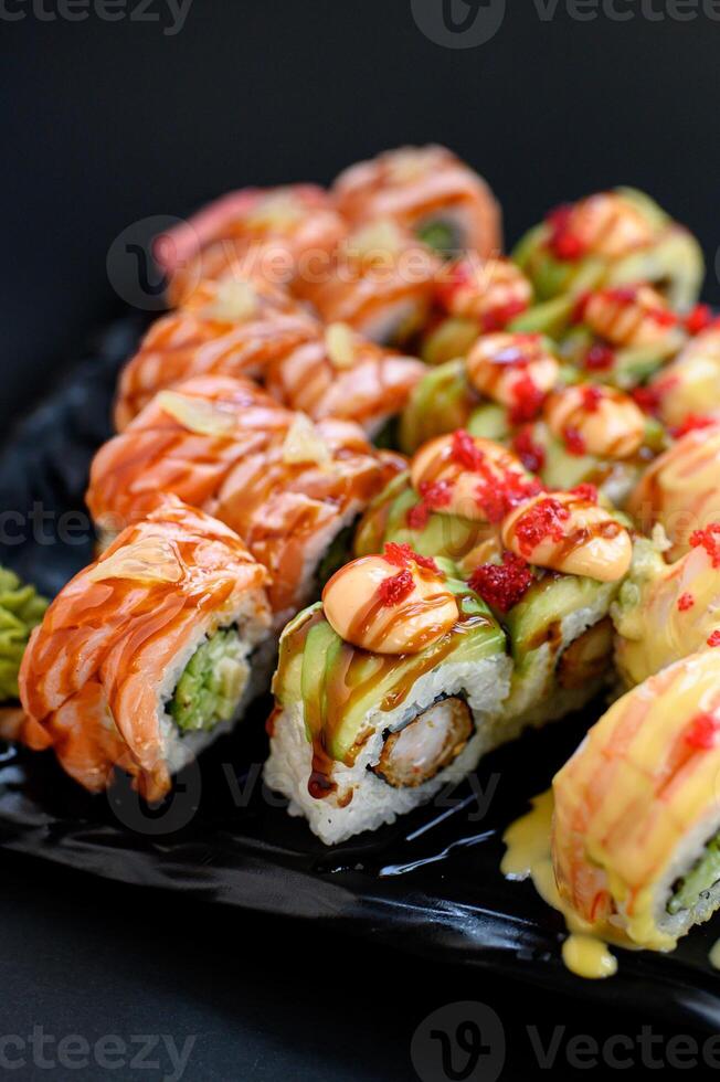 Mixed sushi selection styled for a modern dining concept, set against a dark background. photo