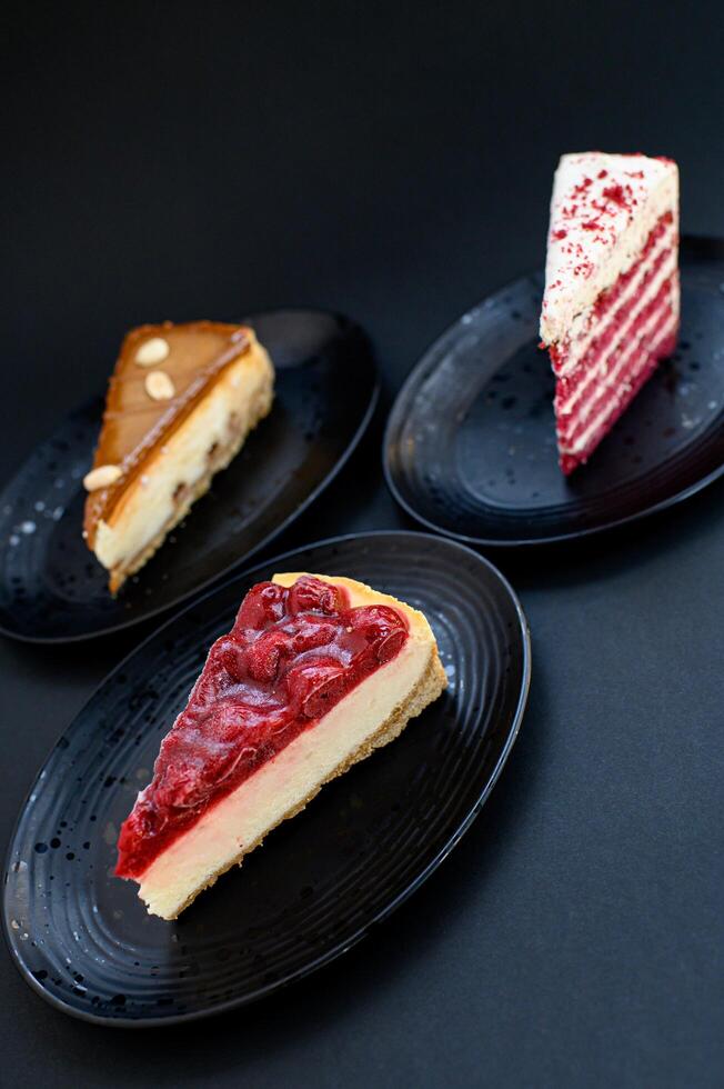 A restaurant-style dessert trio featuring cherry cheesecake, caramel cheesecake, and red velvet cake, beautifully arranged for a refined menu presentation. photo
