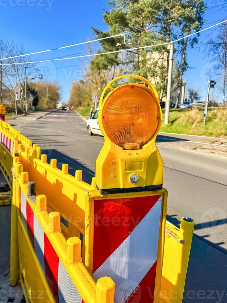 Flashing Warning Light on Road Barrier, Construction Site Safety, Urban Area. High quality photo