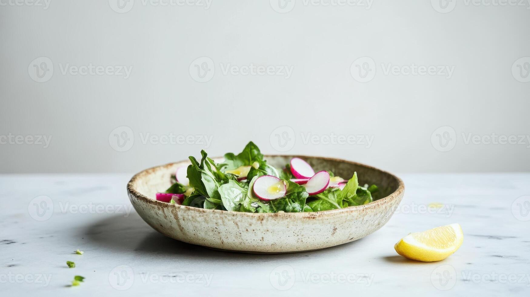 A vibrant mix of organic greens arugula,and butter lettuce tossed with thinly sliced radishes scattered with toasted pumpkin seeds for texture. photo