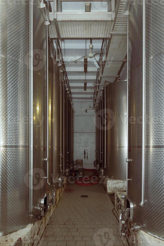 Rows of stainless steel tanks filling a wine cellar photo