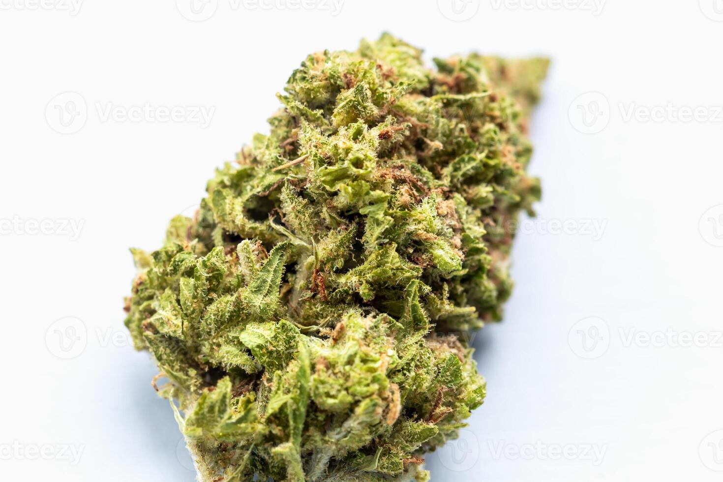 Macro image of single cannabis bud on white background, showing texture, trichomes and vibrant green tones for use in medical, wellness or lifestyle contexts. Close-up of cannabis flower bud photo