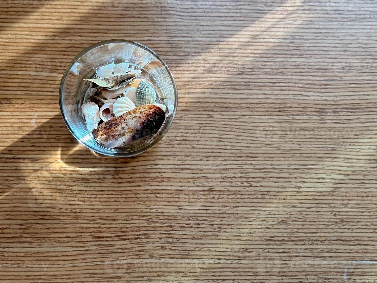 Copyspace with top view glass of shells on wood table photo