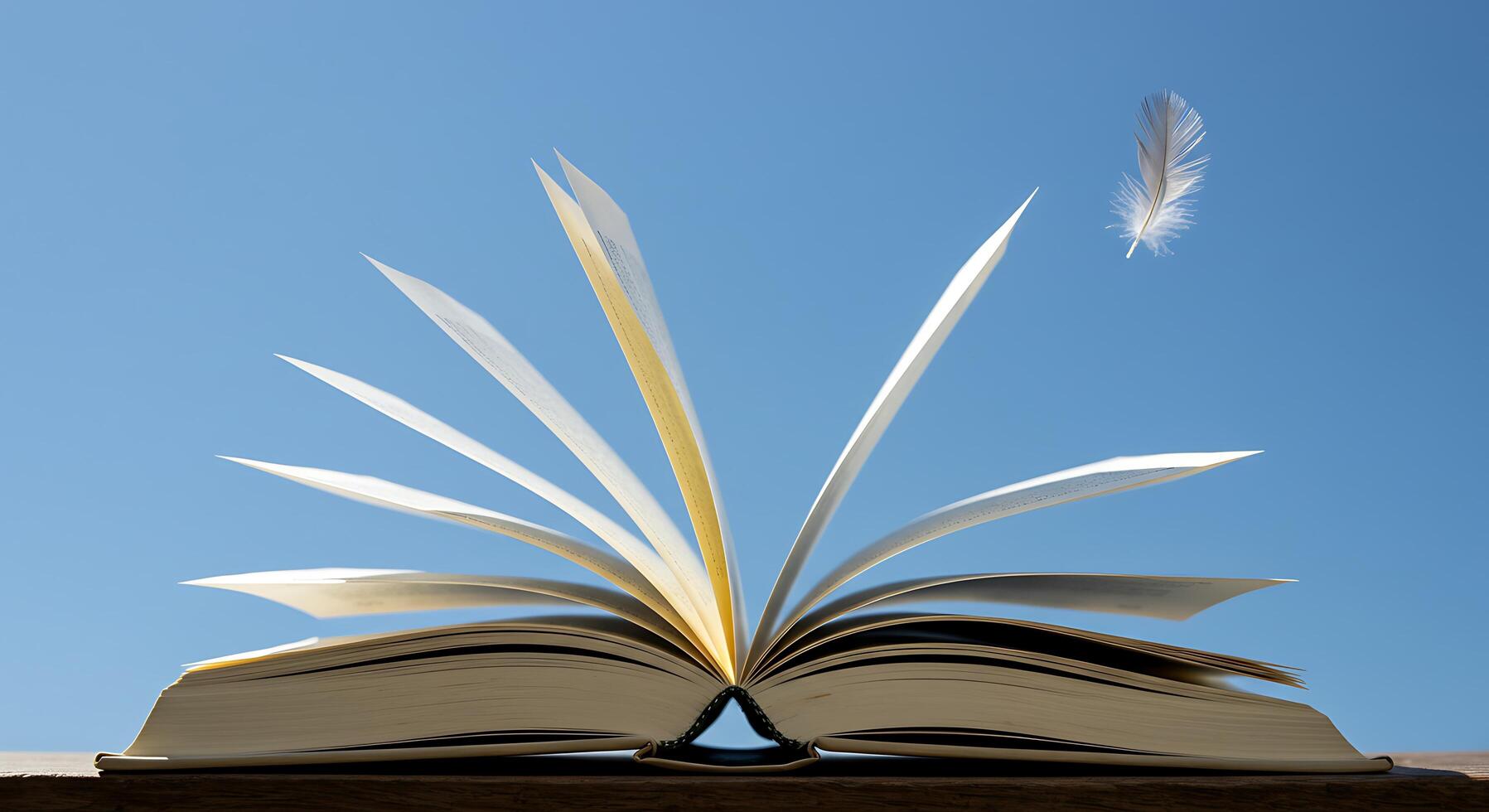 Open Book and Feather Soaring Under a Clear Blue Sky photo