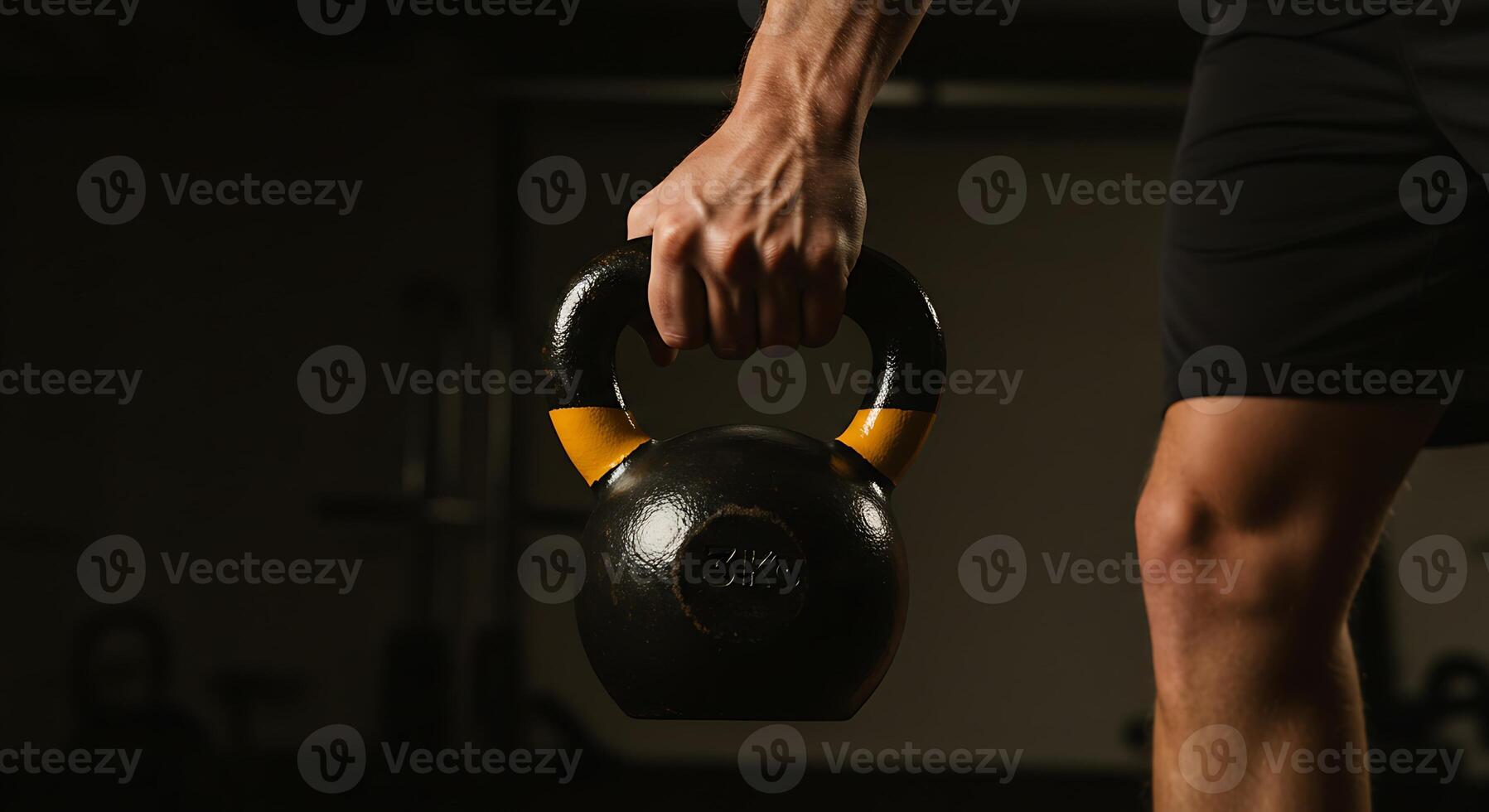 Man Lifting Kettlebell in Gym photo
