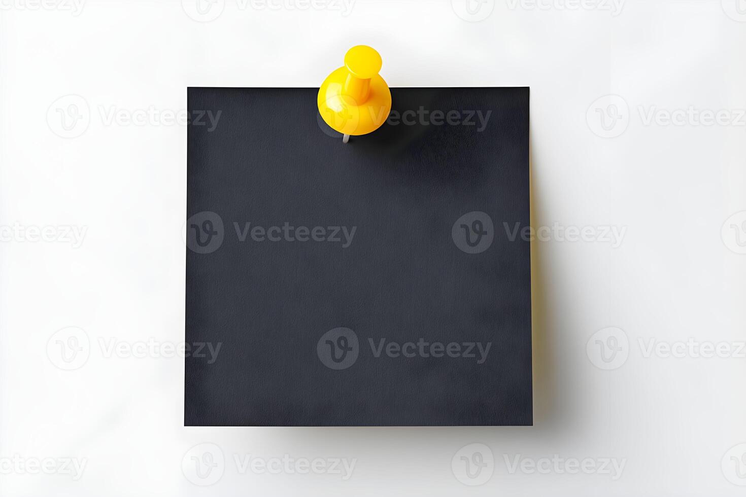 Yellow push pin holding blank black note on white background for reminders or messages at office or home workspace photo