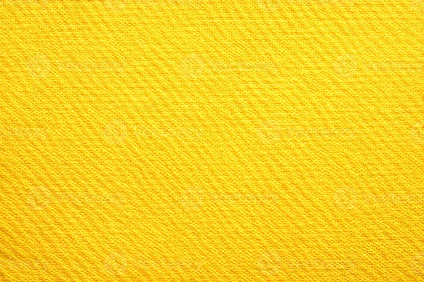 Vibrant yellow textile fabric showcasing intricate woven patterns in natural light photo