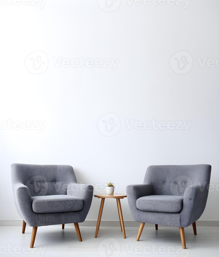 Empty wall with blank copy space framed by two modern chairs and a side table, creating a minimalist interior design aesthetic photo