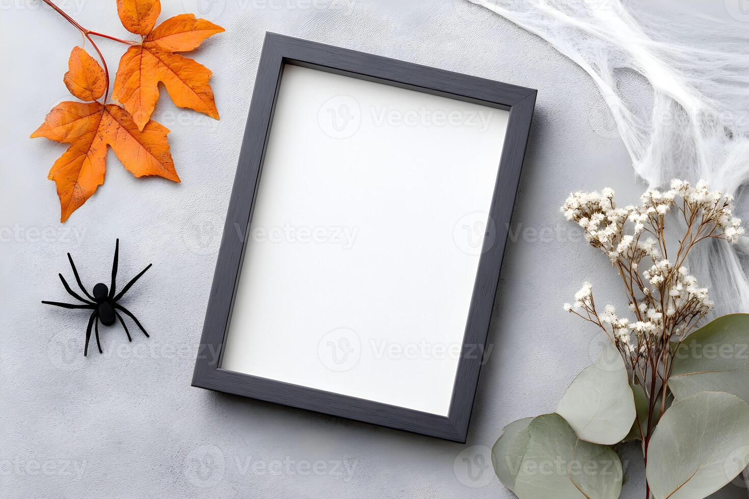 Blank frame for wall art mockup featuring modern design with dried leaves, spider decor, and natural elements, perfect for autumn-themed interior decor photo