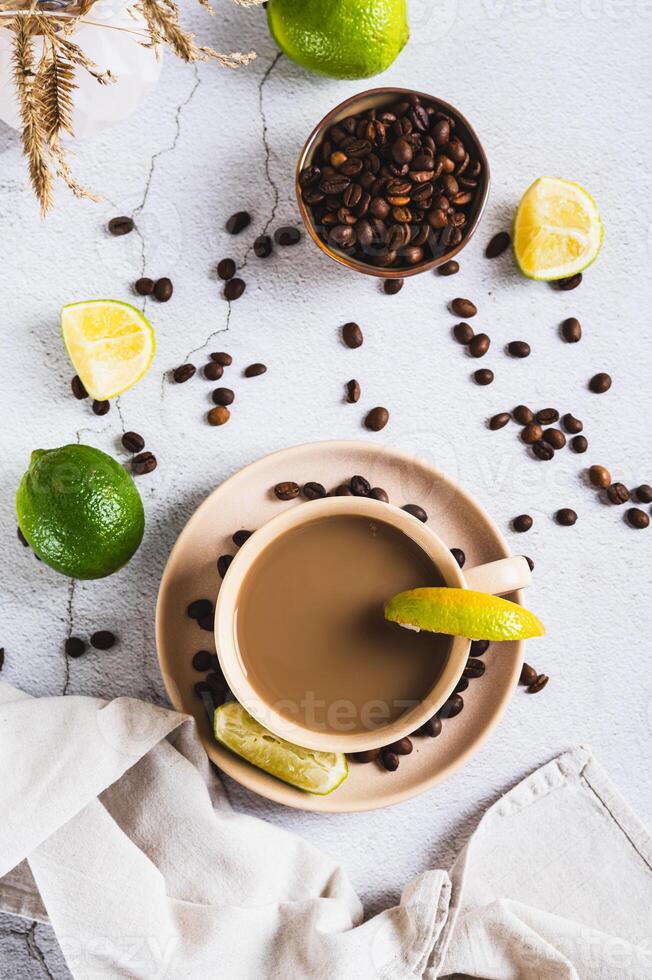 A cup of latte infused with lime on the table top and vertical view photo