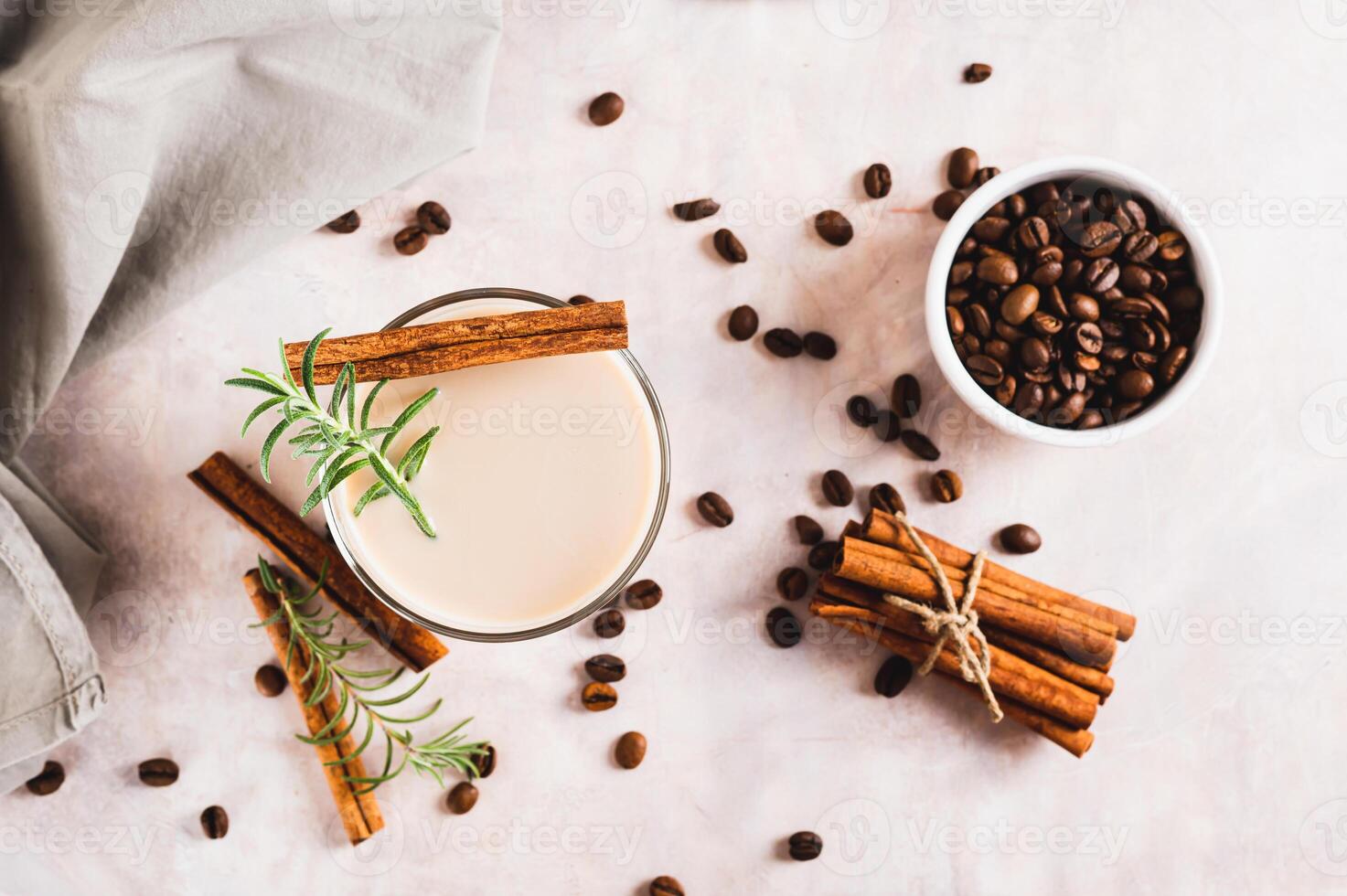 Aromatic coffee with rosemary and cinnamon in a glass on the table top view photo