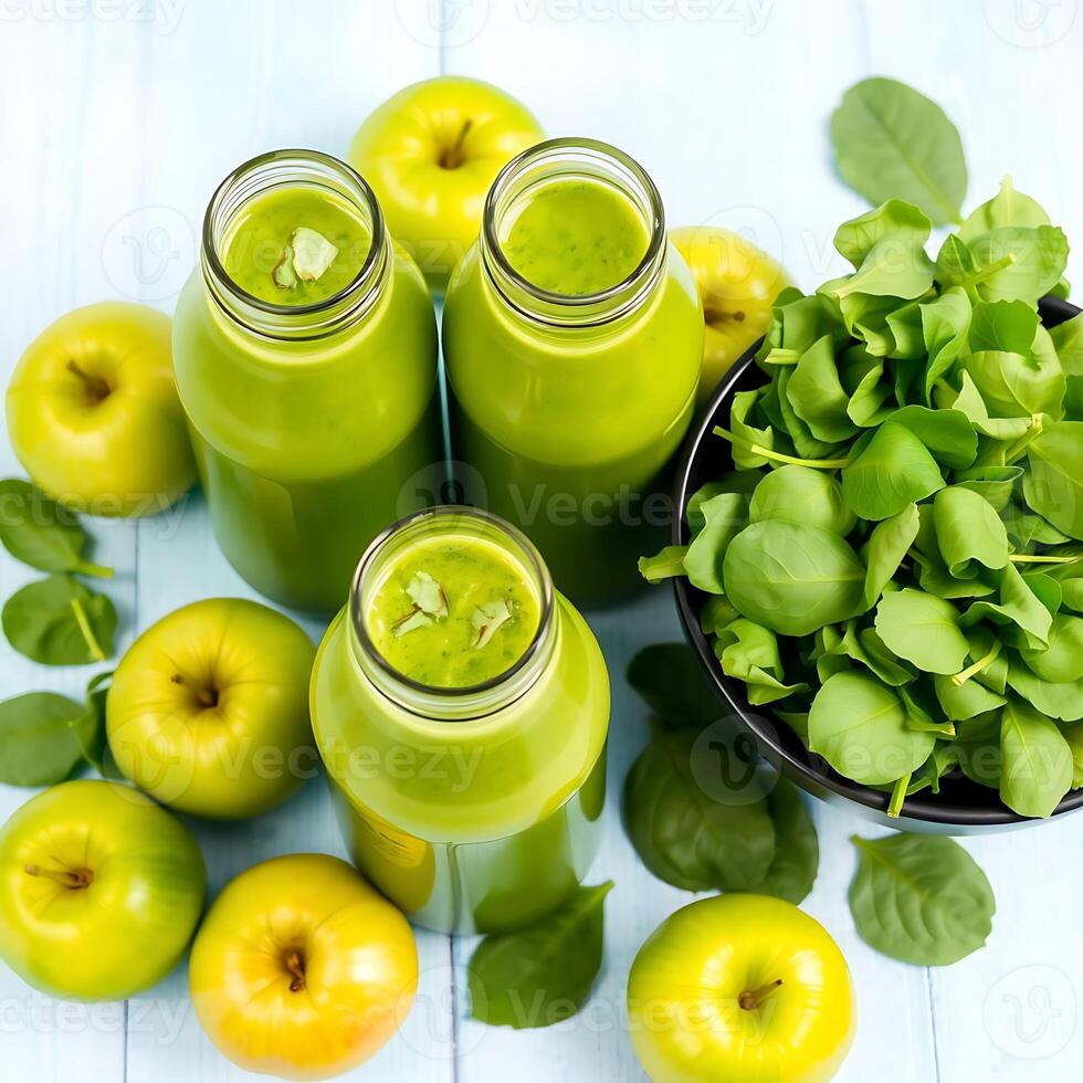 Healthy green smoothie with spinach and apple in glass bottles on light blue wooden background for wellness photo