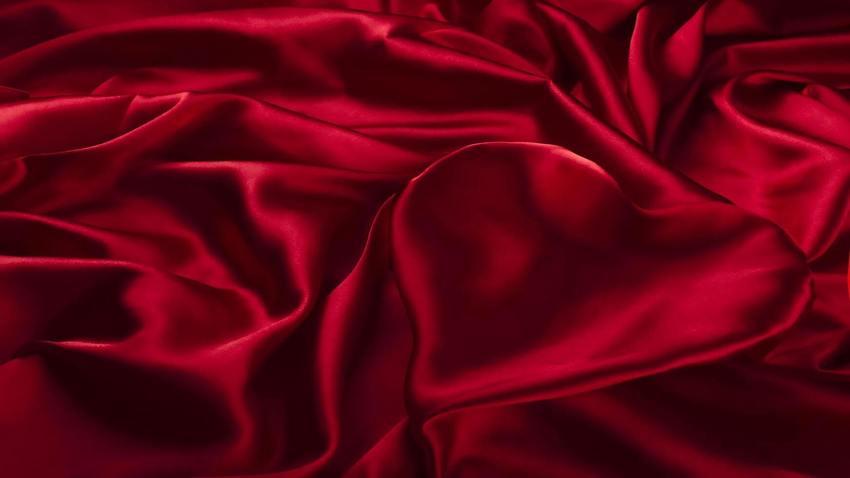 A red satin fabric with a heart shape photo