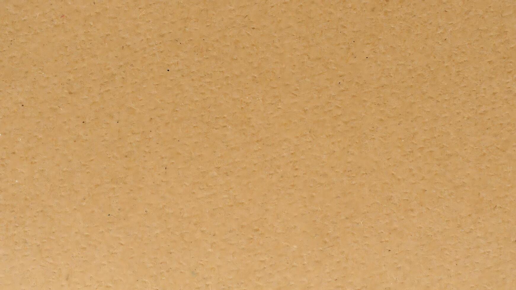 A brown paper texture background with a few small dots photo
