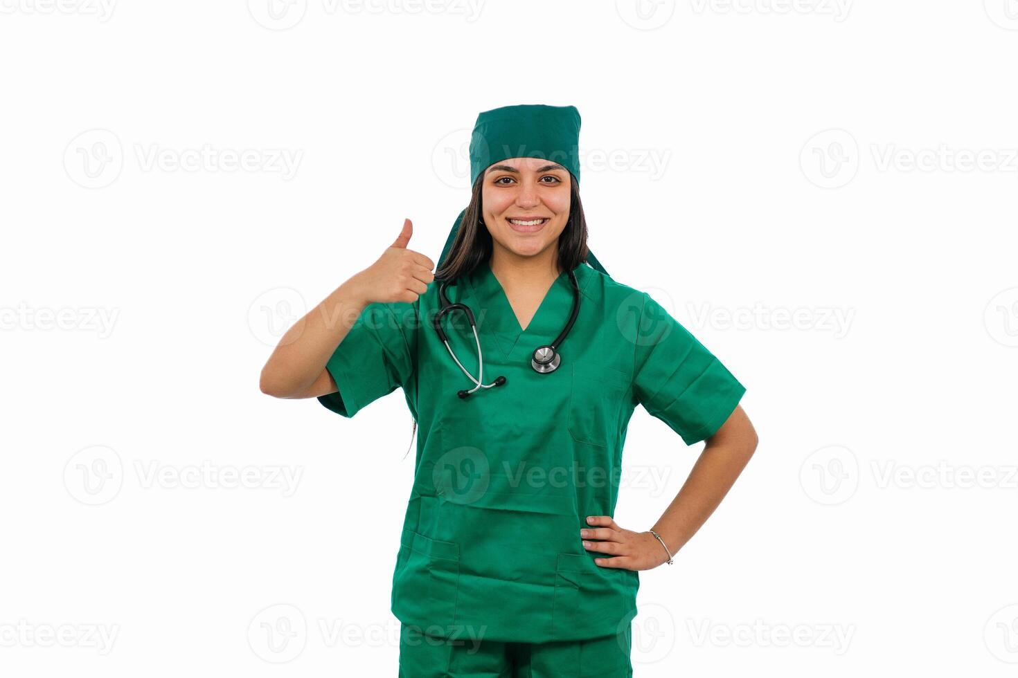 Latin female surgeon gesturing thumbs up wearing green scrubs and stethoscope photo