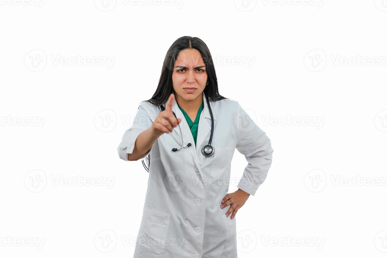 Serious latin doctor pointing finger with angry expression on white background photo