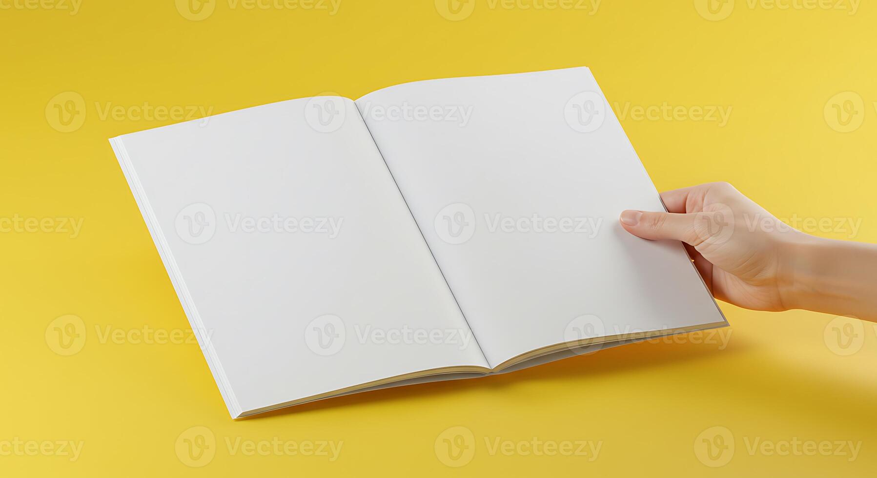 Hand Holding Open Book with Blank Pages on Yellow Background photo