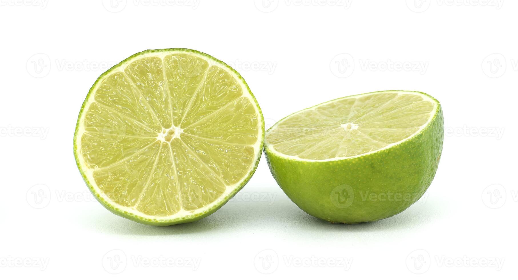 Two lime halves showing pulp and peel on white background photo