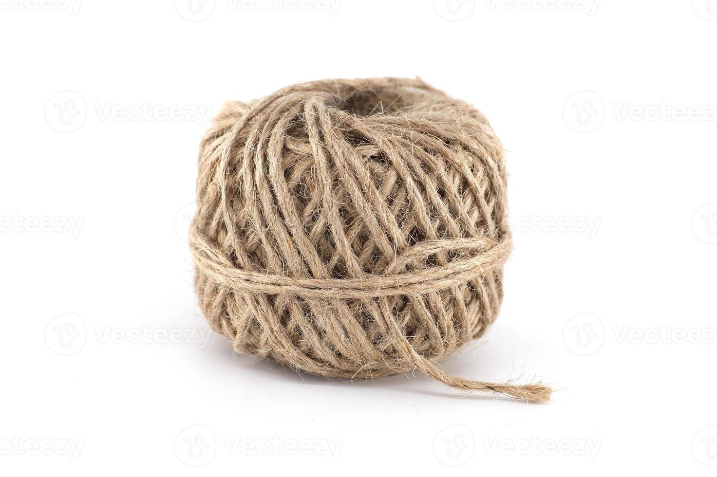 A ball of natural twine on a white background, perfect for crafts and tying. photo