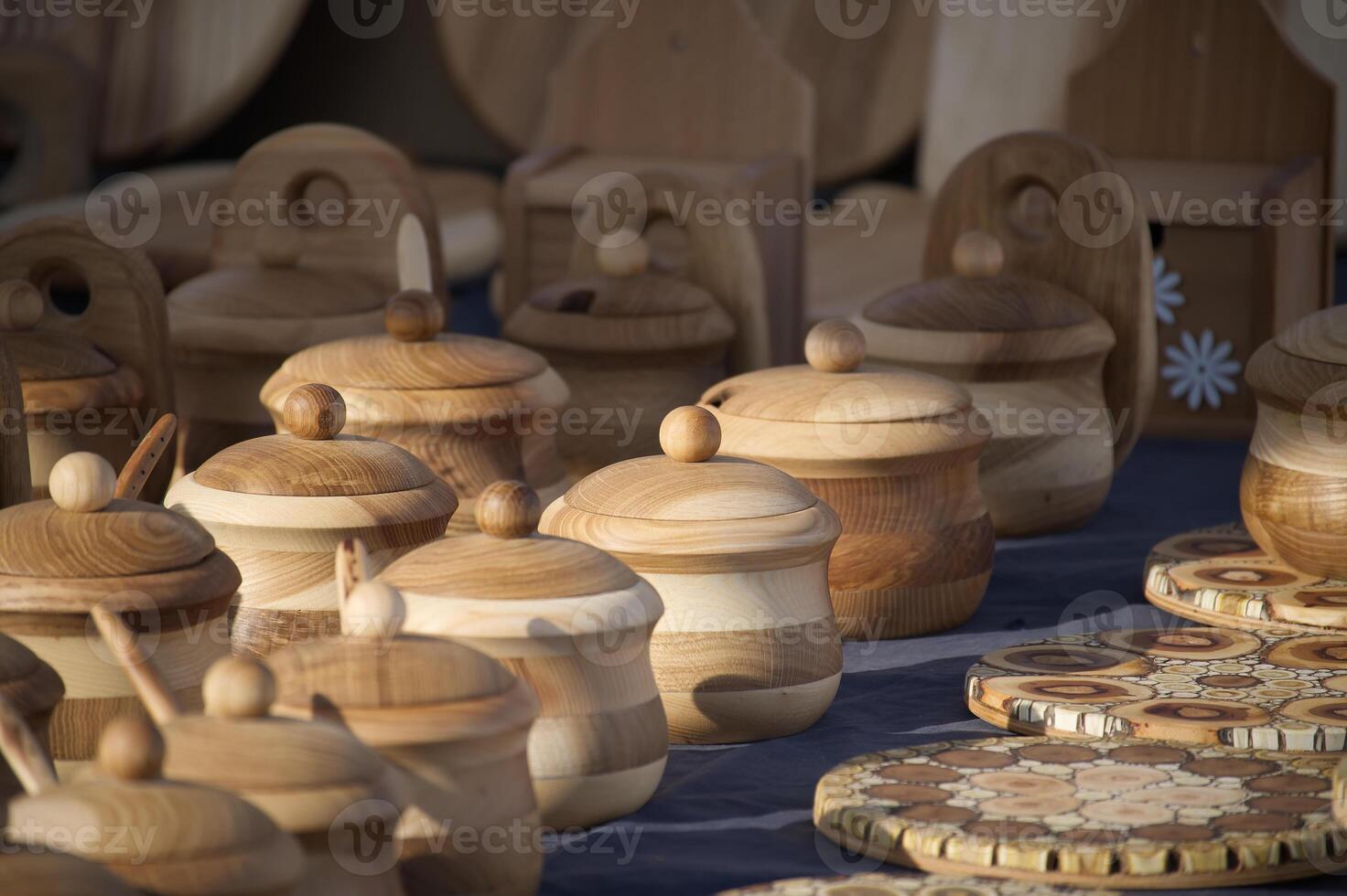 Handcrafted wooden containers and kitchenware add rustic charm to this artisan market stall display. photo