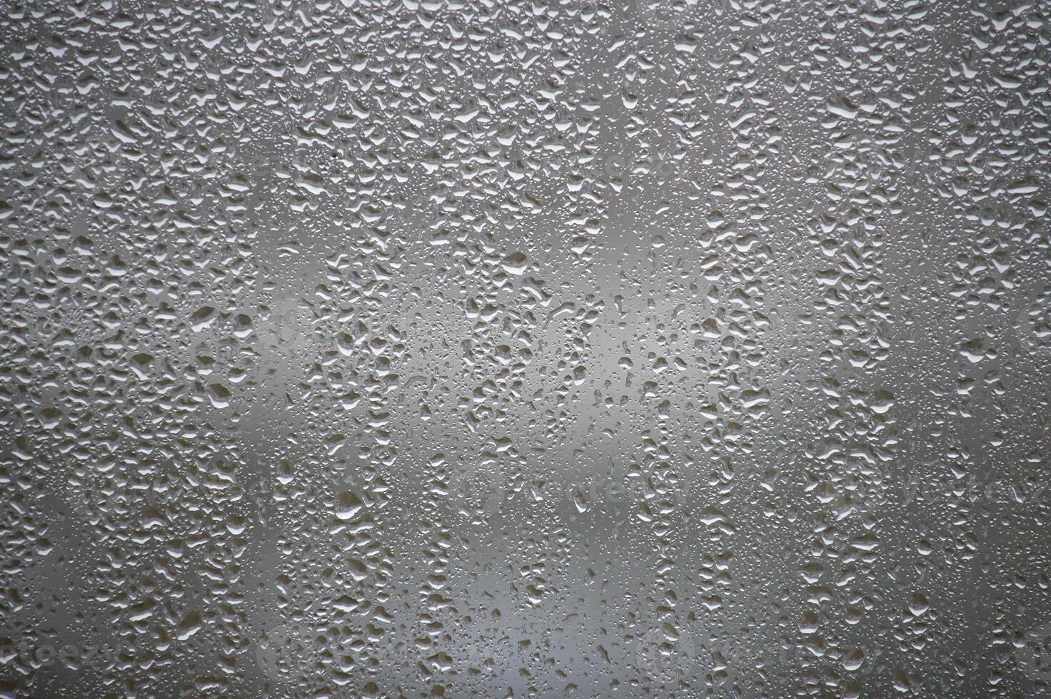 Water Droplets on a Foggy Glass Surface With Light Reflections photo