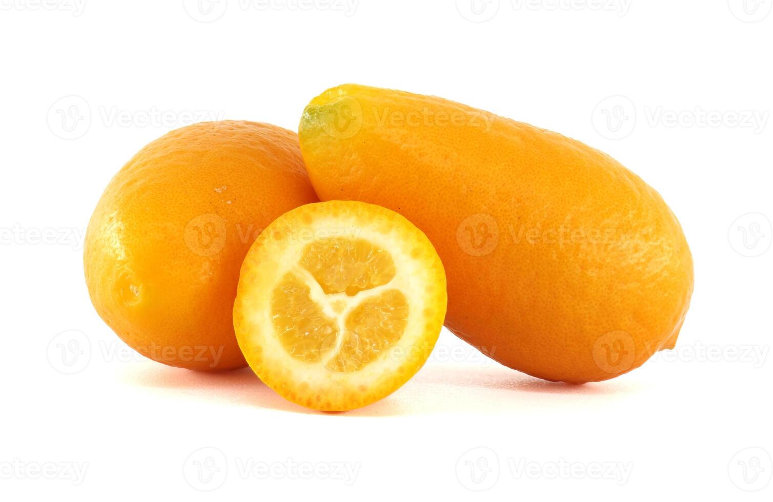 Fresh yellow kumquats showing pulp and peel on white background photo