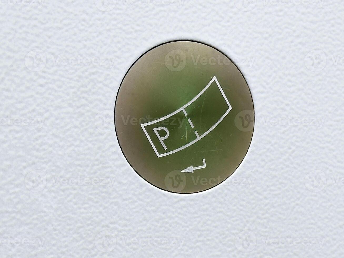 Close-up of circular sticker on textured surface with pt arrow design photo