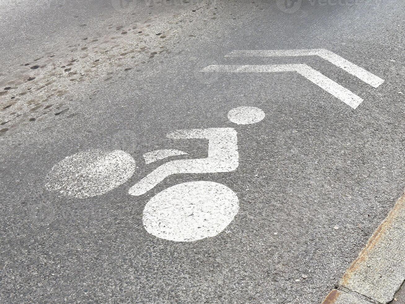 Bicycle lane road marking with directional arrows on asphalt street surface photo