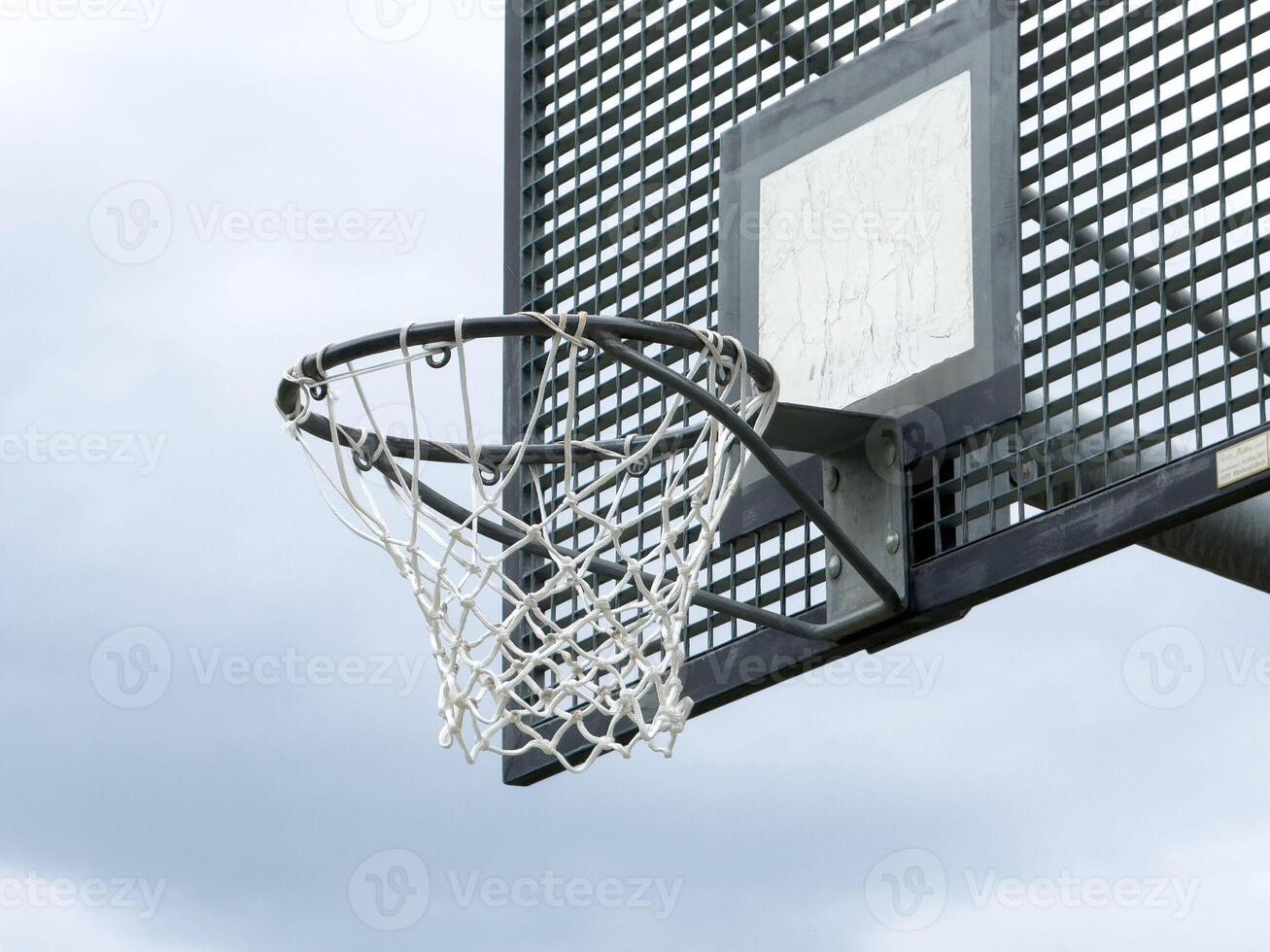Outdoor basketball hoop on overcast day photo