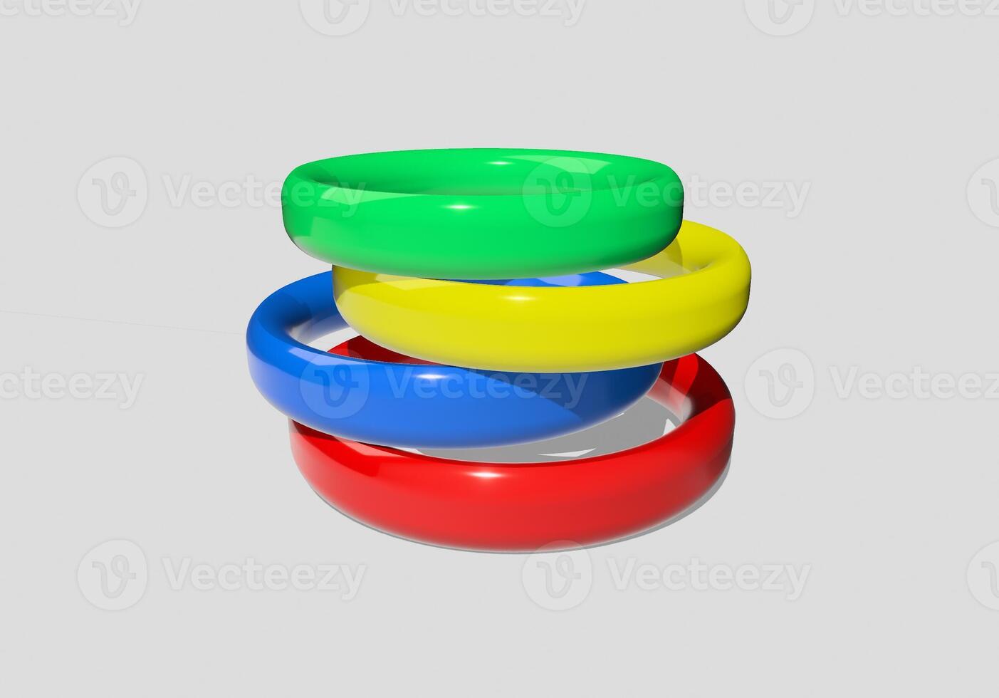 A stack of three colored rings on a white surface photo
